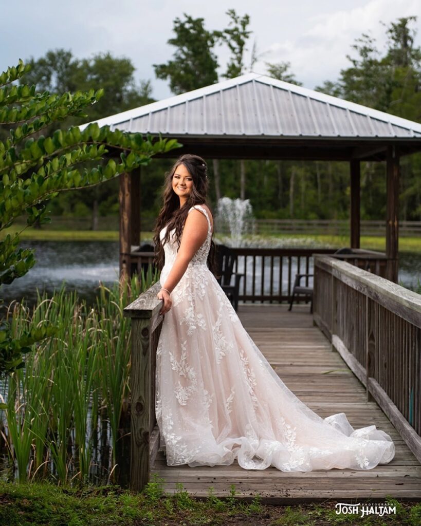 bride posing at the pond walkway