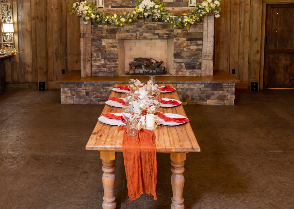 wood table and red linen table setting