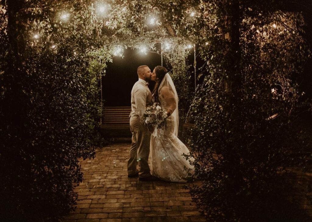 wedding couple in the swing pergola