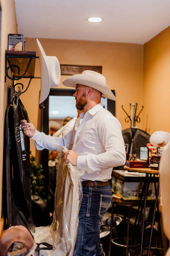 groom getting dressed for wedding