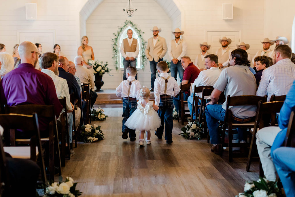 ring bearers and flower girl walking gown aisle