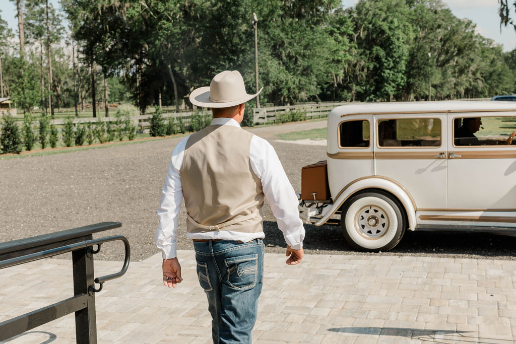groom walking toward getaway car