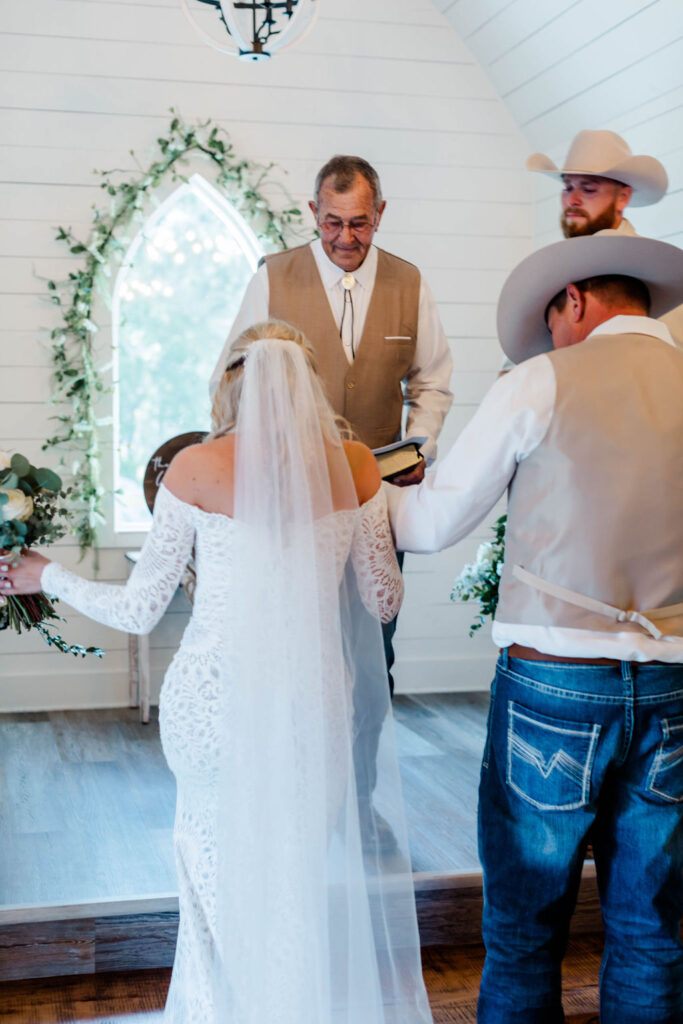 father giving away bride at altar