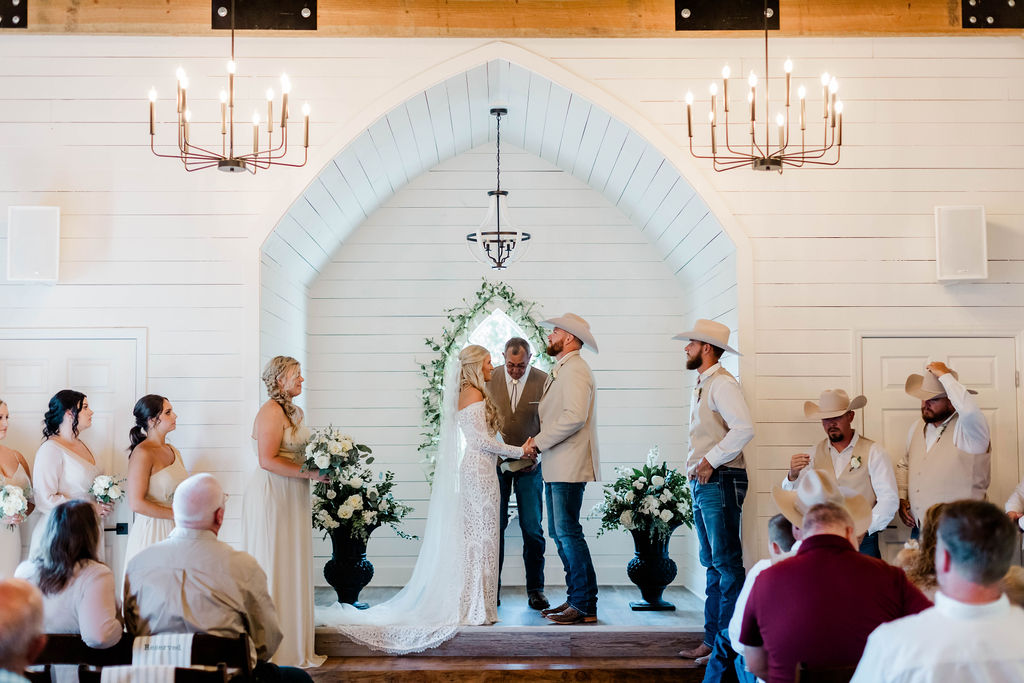 bride and groom saying vows at altar