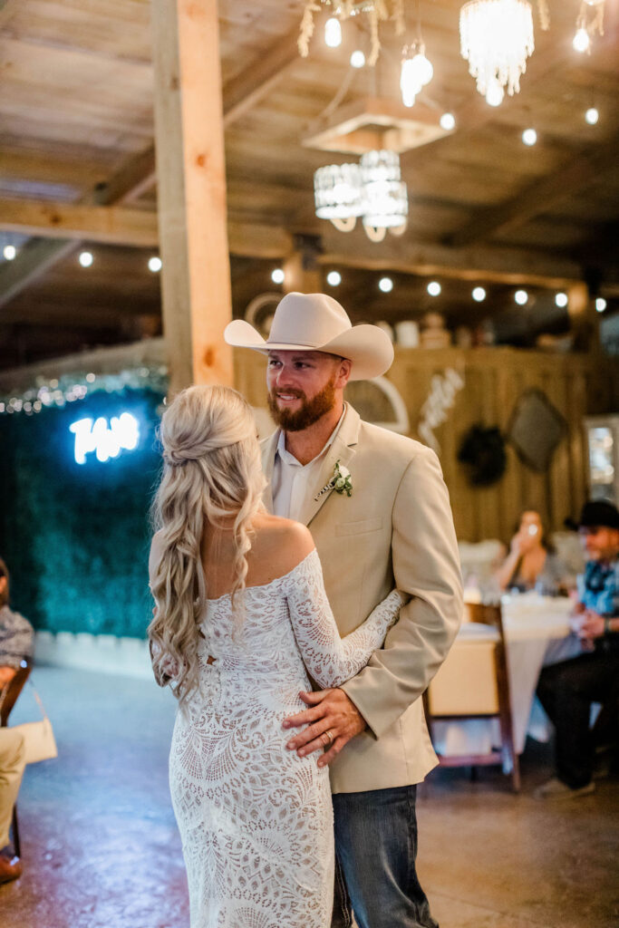 bride and groom dancing in barn venue