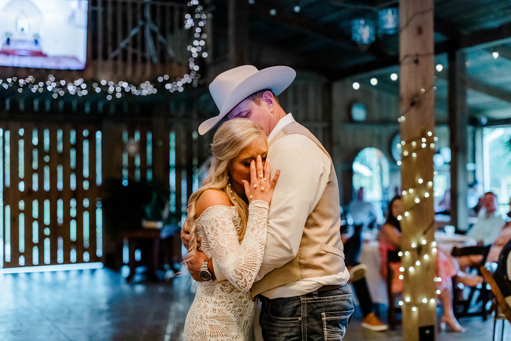 bride crying and hugging groom