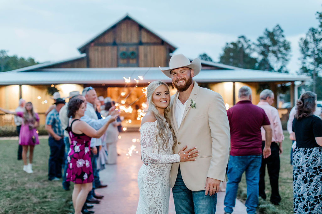 bride and groom in front of barn venue