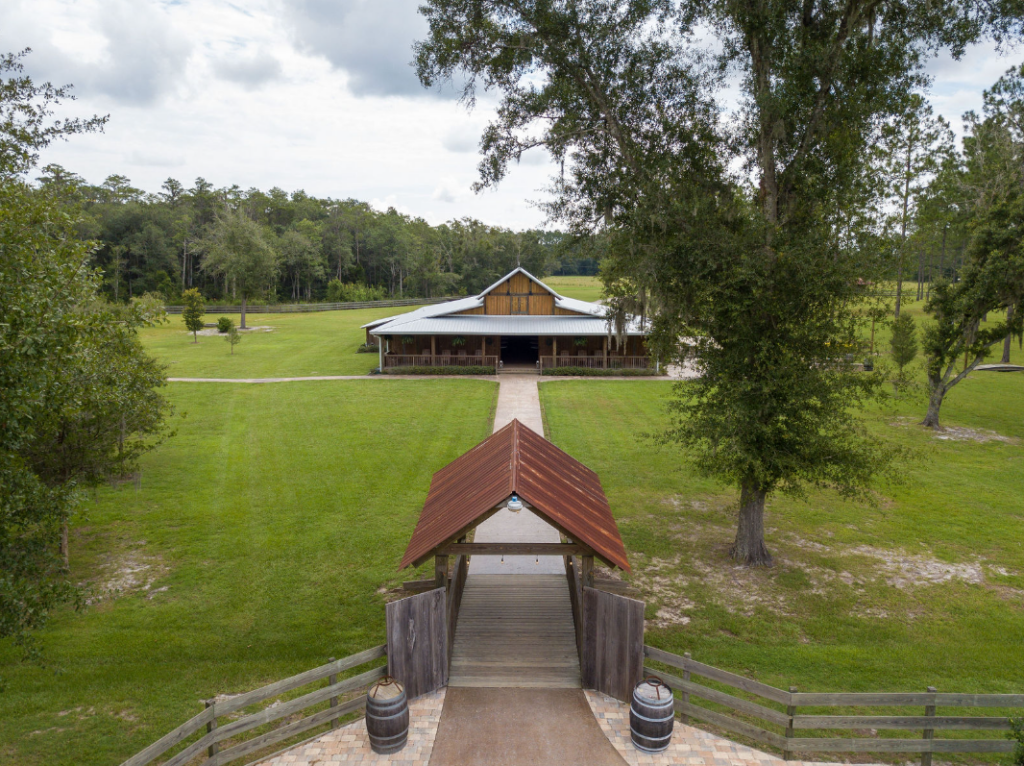 aerial view of covered bridge leading to wedding venue