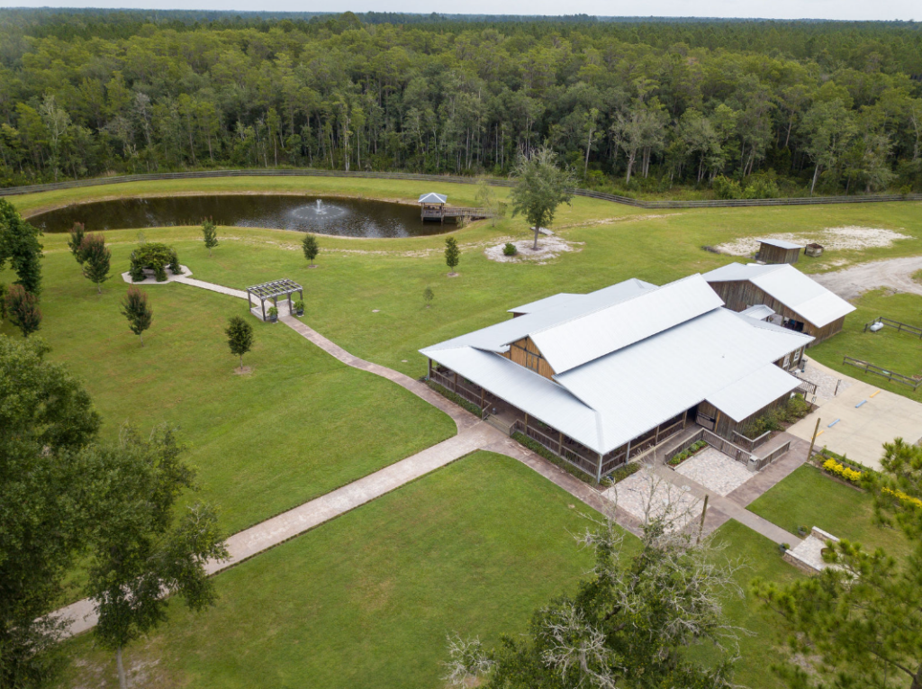 aerial view of belle oaks barn venue with scenic pond