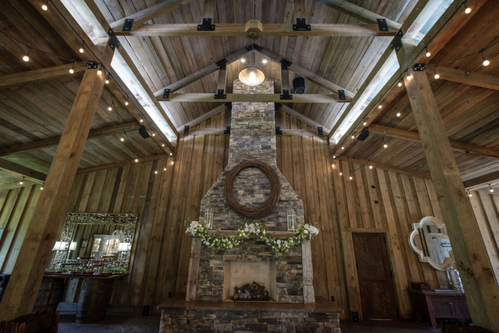 large stone fireplace inside belle oaks barn
