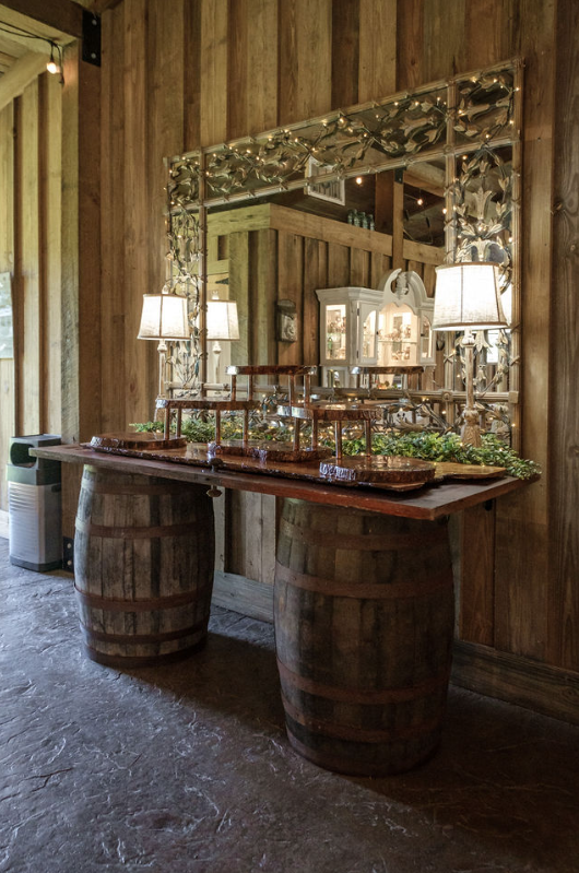 wedding cake table made from antique whiskey barrels