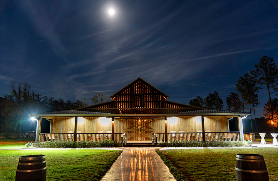 nighttime photo of belle oaks farm main barn