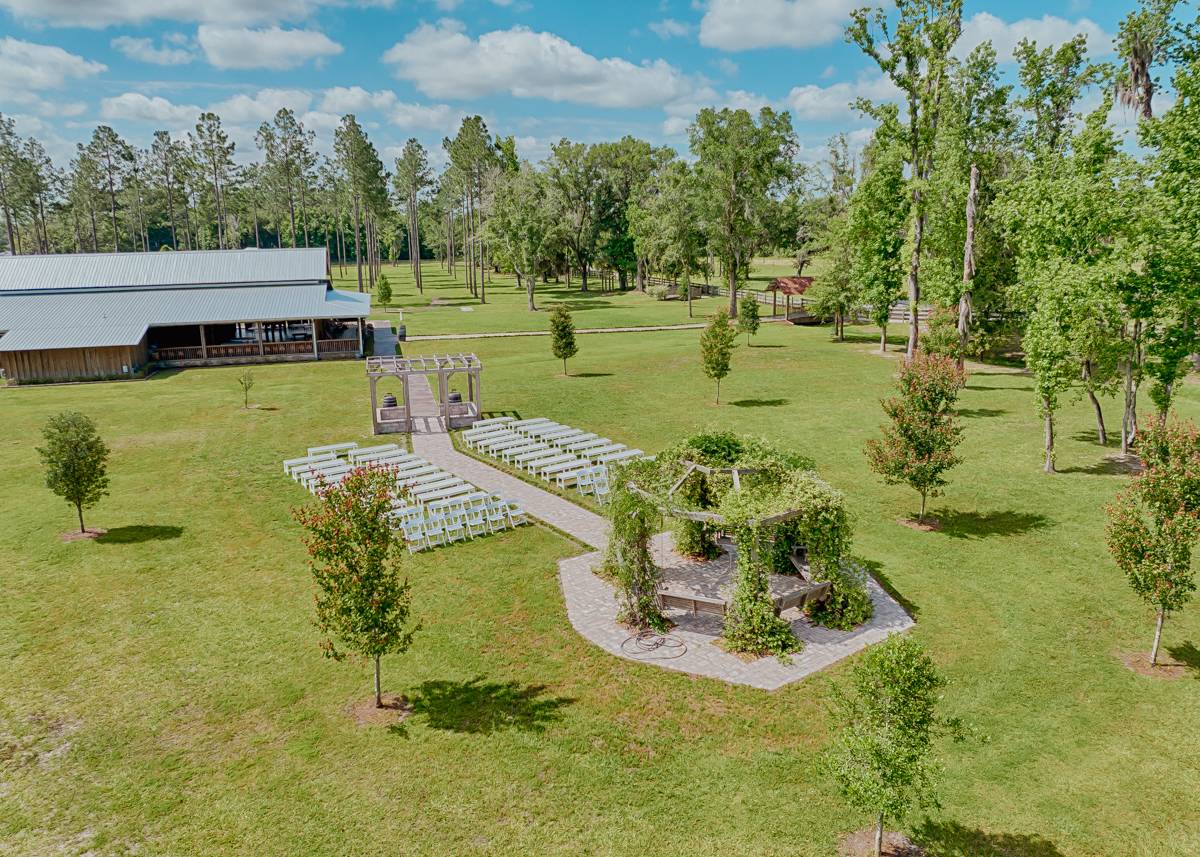 belle oaks barn ariel view of ceremony option and main barn in the back showing green grass property